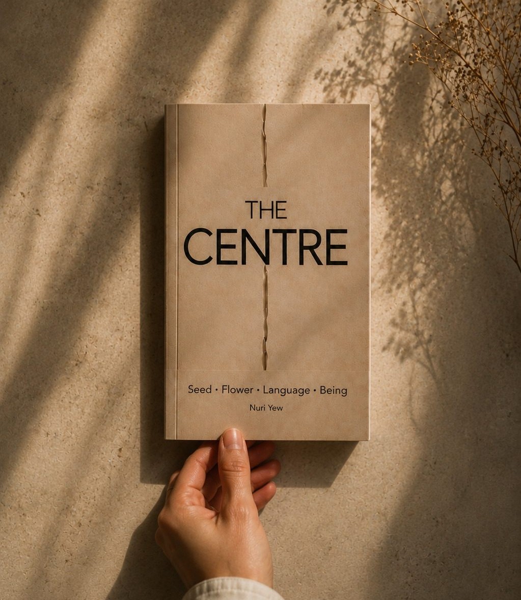 The Centre by Nuri Yew, held against a sunlit stone wall